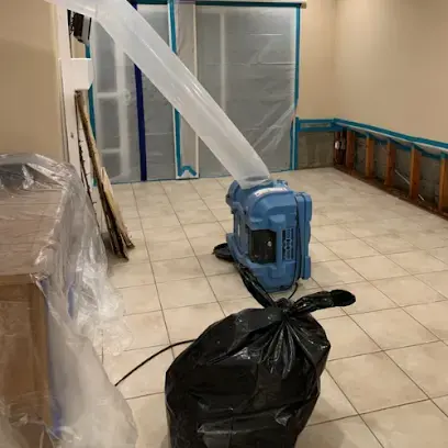 Air scrubber and containment plastic in a tiled Costa Mesa room
