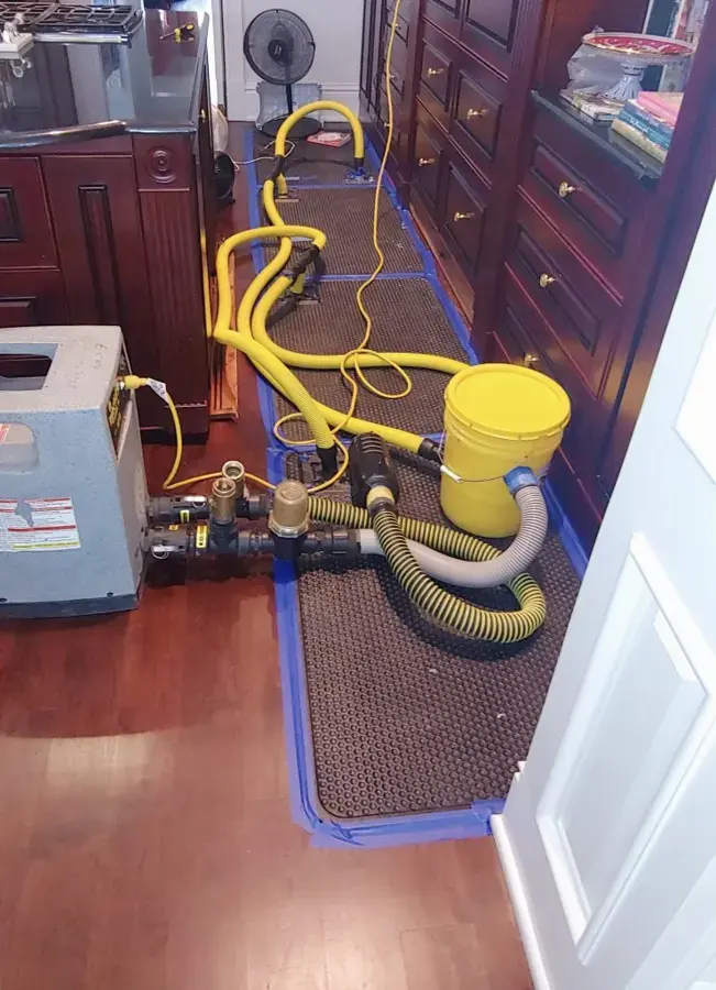 Drying mats and hoses on a Costa Mesa wood kitchen floor