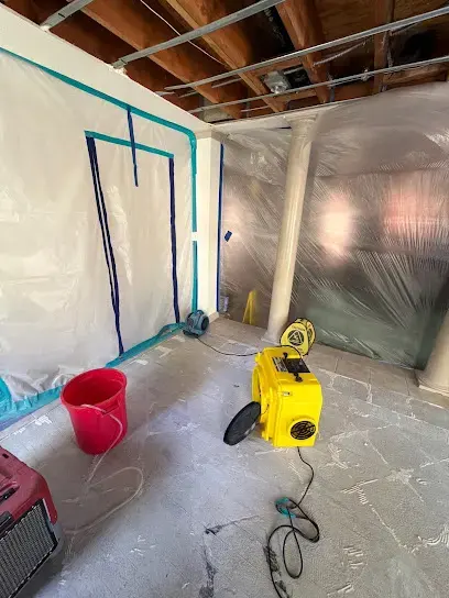 Containment plastic and an air mover in a room with the ceiling opened
