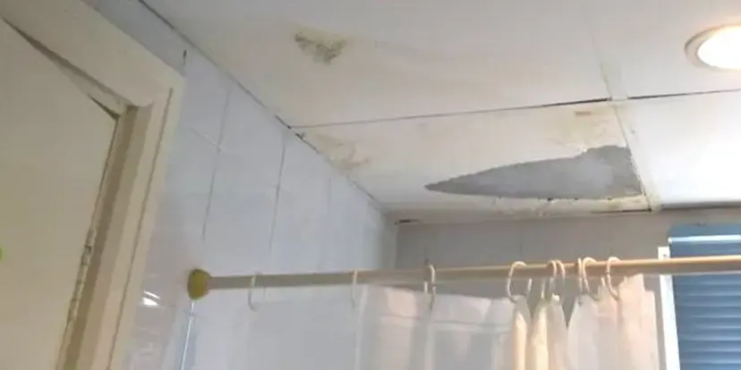 Water damage on the ceiling of a bathroom above the shower